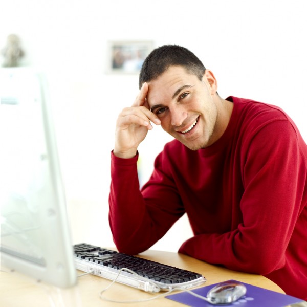 Young Man Sitting at a Computer
